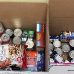 Boxes filled with canned and dry food donations.