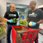 Some Pro employees helping to stock the shelves of the Franklin Food Bank market with fresh produce