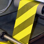 Custom safety tape being printed.