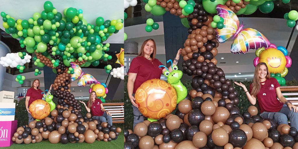 The Globos Manas in front of a giant balloon sculpture of a tree