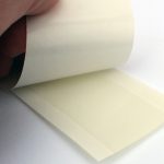 UGlu® adhesive 1”x3” strips on double extended liner for ease of use.