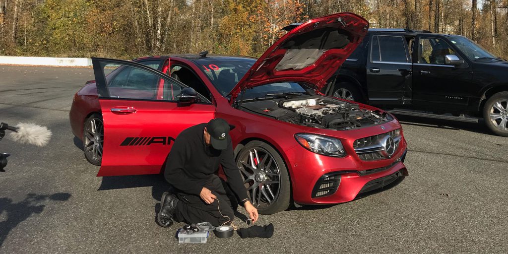 Watson Wu rigging microphones to a Mercedes-AMG e63S car using Pro Gaff® tape